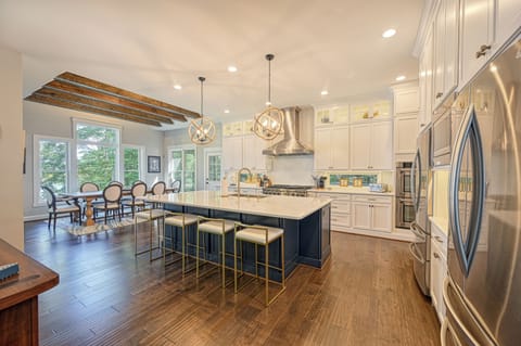 Massive open kitchen with bar seating and  multiple dining areas.
