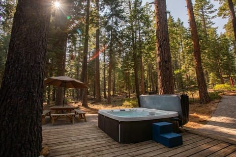 Enjoy a soak in the hot tub or a meal at the picnic table as you take in the surrounding trees and peaceful surroundings.