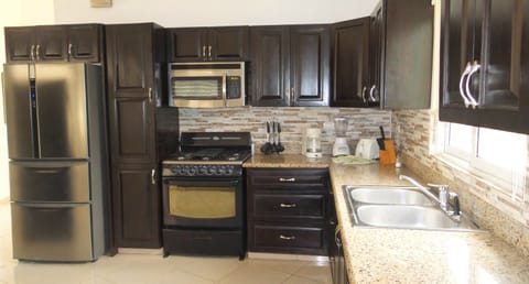Fridge, cookware/dishes/utensils, dining tables