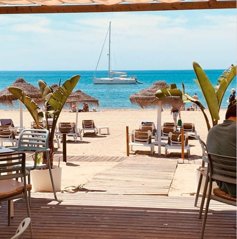 On the beach, sun loungers, beach towels