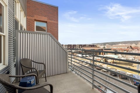 The Patio - view from doorway. Four chairs and two with cushions.