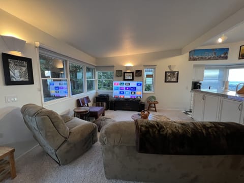 TV room w/ comfortable furniture. Games and blankets in cabinet.