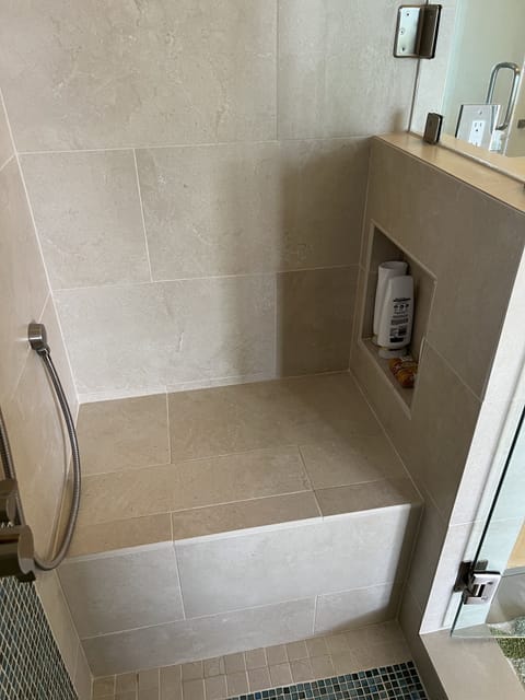 Seat in upstairs tiled shower.