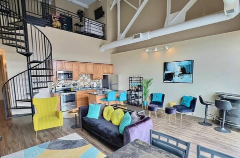 The open concept living space seamlessly blends the kitchen, dining, and living room into one bright inviting area perfect for gathering and relaxing.