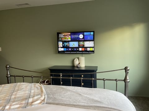 Smart TV provided in primary bedroom. 