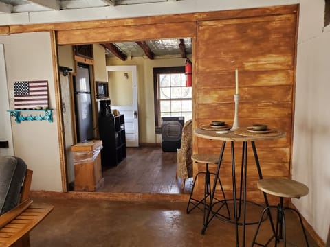 Living Room into the Kitchen, with bar style seating dining table