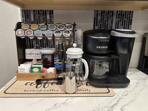 Indulge in the ultimate coffee experience at our coffee bar. Choose from an array of K-cups, enjoy the rich flavor of French press or drip coffee, or opt for a soothing cup of tea. Complete with an assortment of syrups and accoutrements.