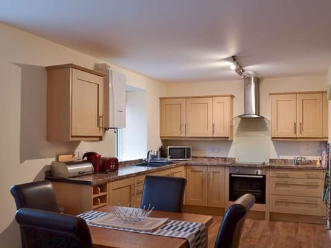 Open plan kitchen leading to dining and living area.
