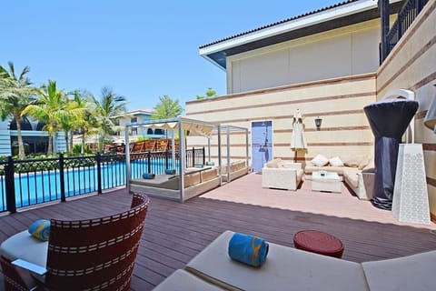 Beautiful large sun deck with sunbeds, cabanas, various seating, outdoor shower, patio heater, with direct lagoon pool access