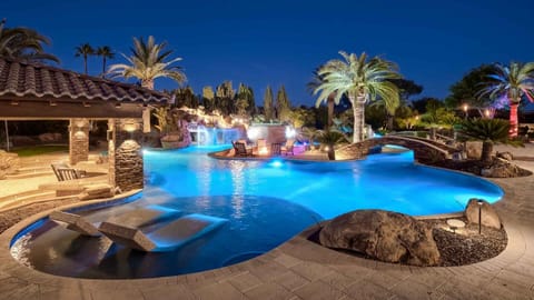 Breathtaking pool w/ lazy river, spa, & waterfalls surrounded by palm trees