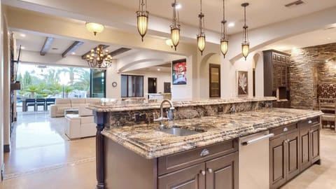 Chef’s kitchen with granite counters, custom lighting, and open views.