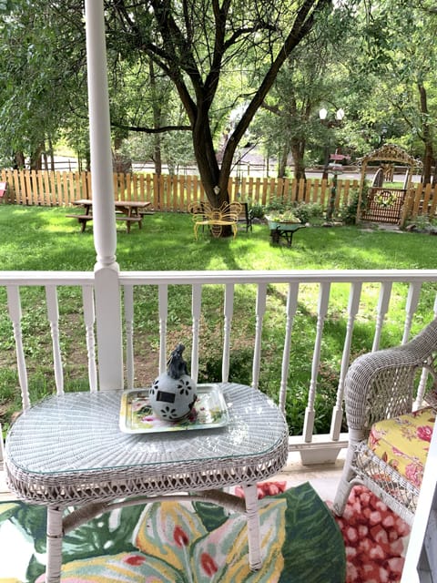 The lovely back porch with views to the bridge and antique lightpost. 