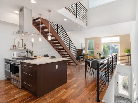 Living, dining and kitchen spaces with beautiful lofted ceilings