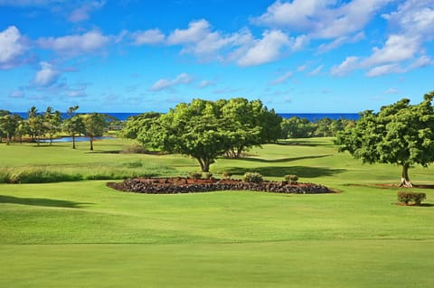 The lanai offers a scenic view of the golf course, blending lush greenery with a peaceful atmosphere.
