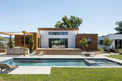 The spacious grounds feature comfortable seating around the pool and on the oversized deck overlooking vineyards.