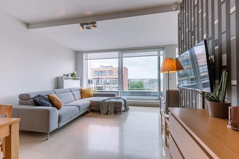 Bright living area with large windows and an open coastal atmosphere.