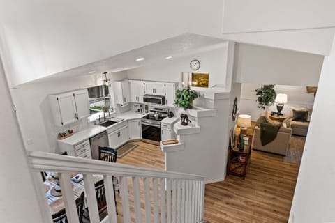 View from top of stairs oversees front family room and kitchen area. 