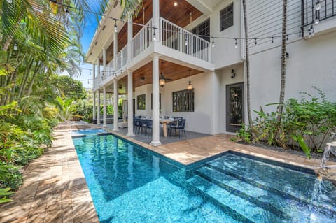 Quintessential Florida Keys style villa updated with modern fixtures, quaint breezy verandas, and towering ceilings. Unwind in the heated pool nestled in a tropical garden.