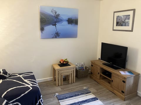 32, living room with TV, maps and local information.