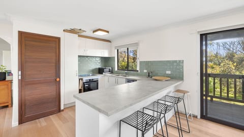 Fully equipped kitchen with modern features, such as ovens, a cooktop, a coffee machine, a dishwasher, a kettle, and a toaster. Basic dishes and utensils, crockery, cutlery, and glassware are also provided.