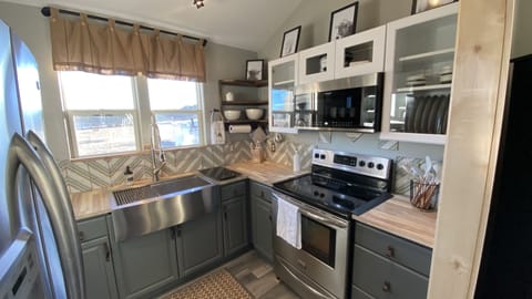Modern farmhouse kitchen with new appliances.