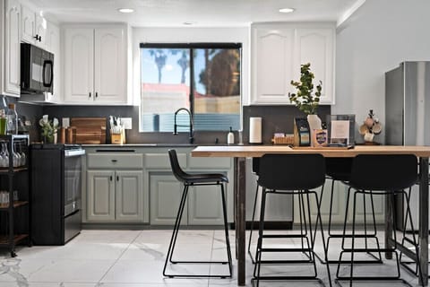 Large, counter high wooden table for extra seating or cooking space.