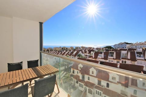 Sunny balcony with outdoor dining area for four guests