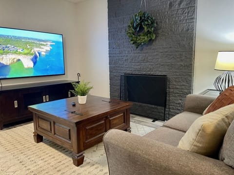 Cozy downstairs bonus room with fireplace and large smart TV