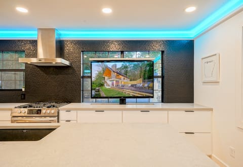 Catch the game or stream your favorites while you cook — this sleek setup combines gourmet functionality with serious fun.