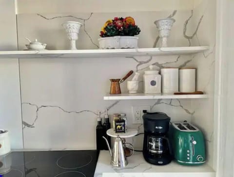 Marble shelving and cupboards with Victorian inspired kitchen utensils 