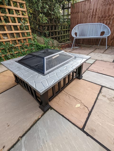 South facing patio area with fire pit.