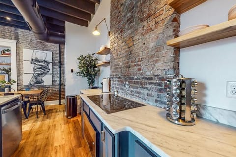 Kitchen: Our kitchen has a spacious counter, organized wooden cabinets, stainless steel appliances, and utensils.