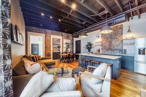 Living Room: The rustic modern design adds warmth to the room, featuring a large sofa, two spacious couches, and a comfy bean bag.