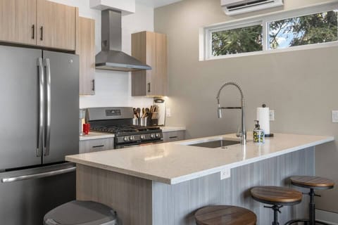 Kitchen with high-end appliances, cookware, dining ware, 3 top bar, 2 top table