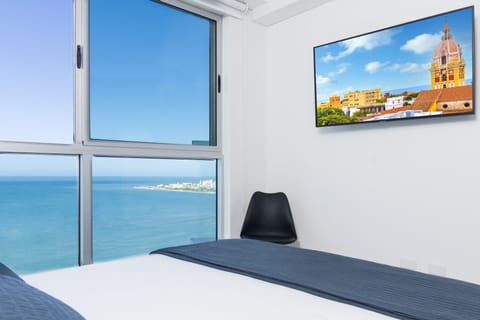 Master bedroom with ocean view and walled city view.
