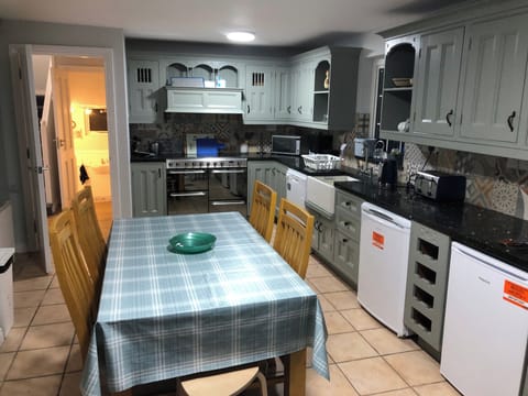 Fully equipped country kitchen with 2 ovens and grill, 6-ring hob, microwave, fridge and freezer and seating for 8 guests with use of 1 high chair.