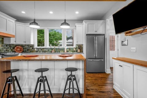 This fully equipped kitchen offers many custom touches, from the waterfall edge cherry peninsula, to the cle-tile back splash.  The huge windows bathe the entire room with natural light!