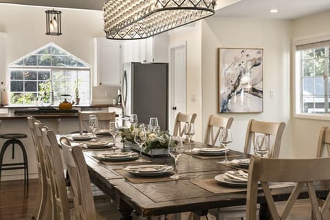 Your grand dining room table easily seating 10 guests, adorned by a rustic and modern crystal chandelier. Break bread, share laughs, and build memories.