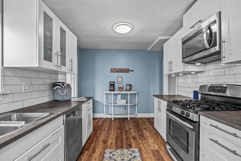 Kitchen, gas stove, blender, toaster, coffee station, cream, sugar