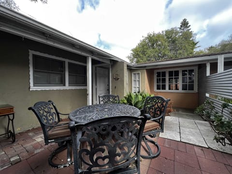 Enclosed outdoor front patio with outdoor seating