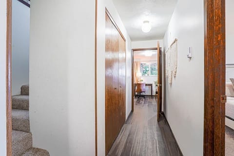 Stairs lead to the bottom floor with 3 bedrooms and 2 bathrooms