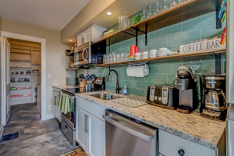 Fully equipped kitchen with cooking and baking essentials. Convenient pantry for storage.