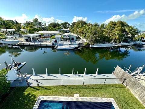 View of the canal, pool and dock from the upstairs terrace.