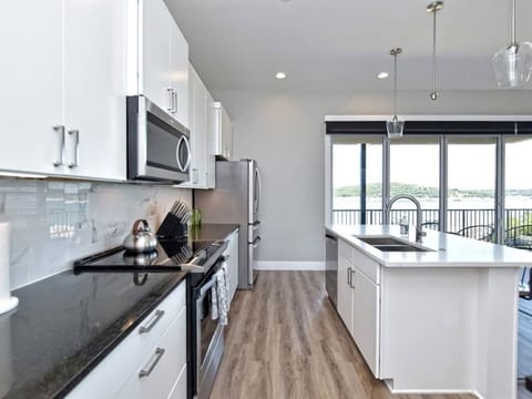 - Fully equipped kitchen with stainless appliances and lakeview - Long counters and bright layout perfect for cooking together - Open design connects smoothly to dining and patio for easy flow
