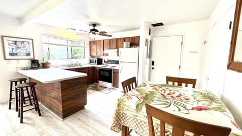 Dinning table with 3 chairs and two bar chairs to seat comfortably 5 people