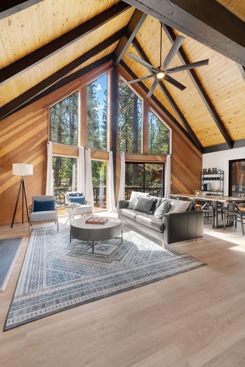 Large windows frame views of the trees.