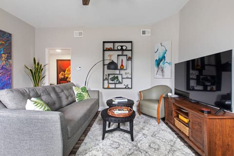 The living room features an eclectic mix of art pieces.