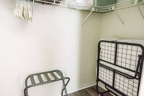 Primary bedroom walk-in closet with twin rollaway bed