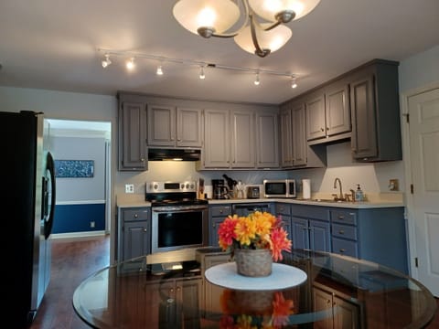 Open kitchen with stainless steel appliances & eat in breakfast table