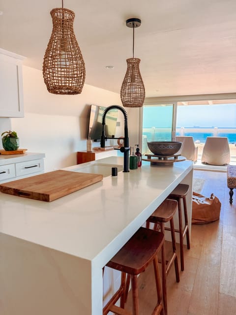 Enjoy a spacious open-concept living area with a sleek kitchen island, perfect for entertaining or a relaxed meal.